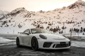 Porsche 911 Carrera Coupe Reimagined by Singer: A Perfect Fusion of Performance and Heritage 12 "Custom Porsche 911 Carrera Coupe Reimagined by Singer, showcasing sleek carbon fiber bodywork, upgraded suspension, and bespoke interior details, blending classic Porsche design with modern engineering."